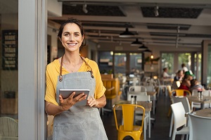 business owner standing outside cafe